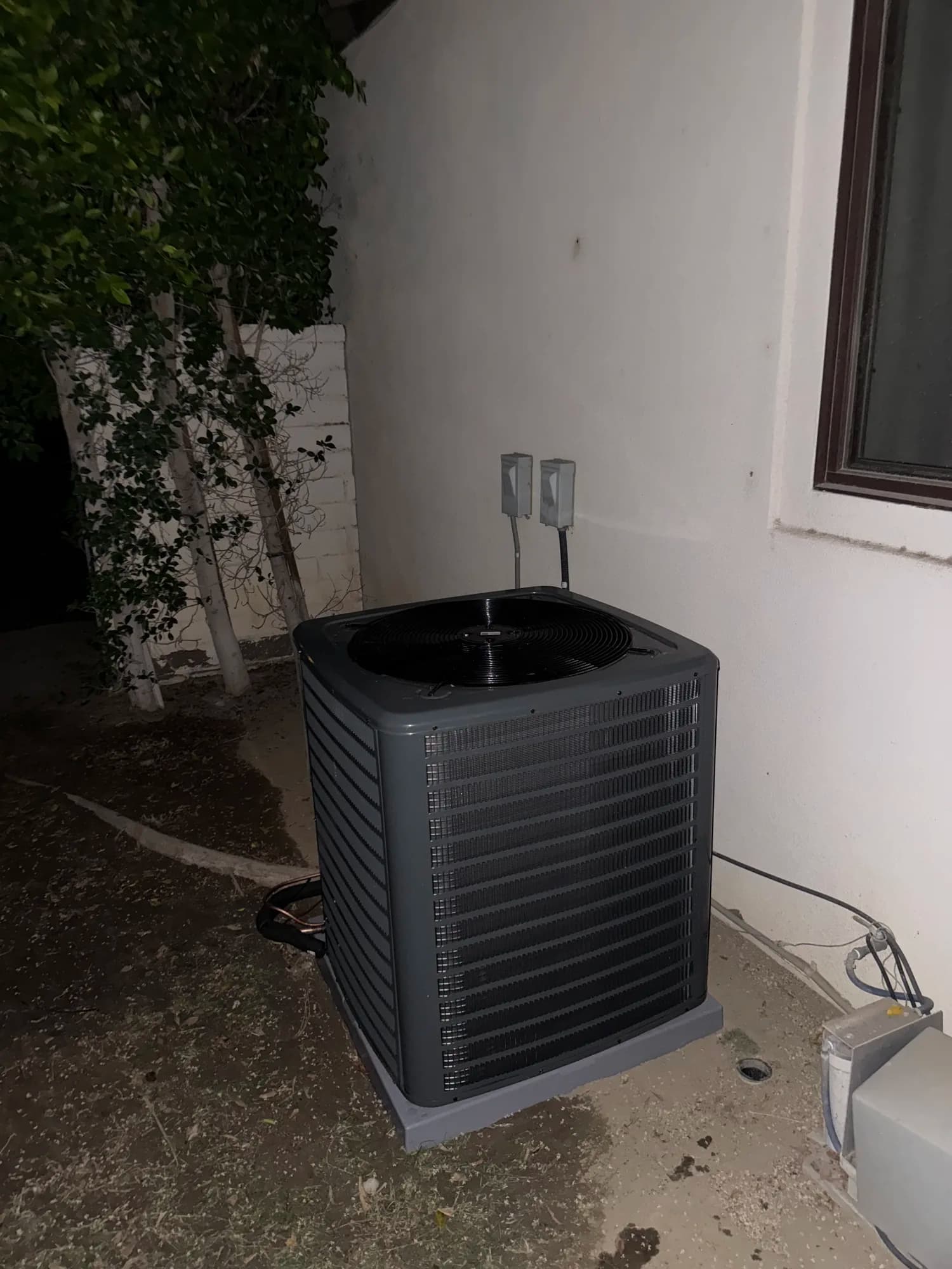 Residential condenser unit beside the home