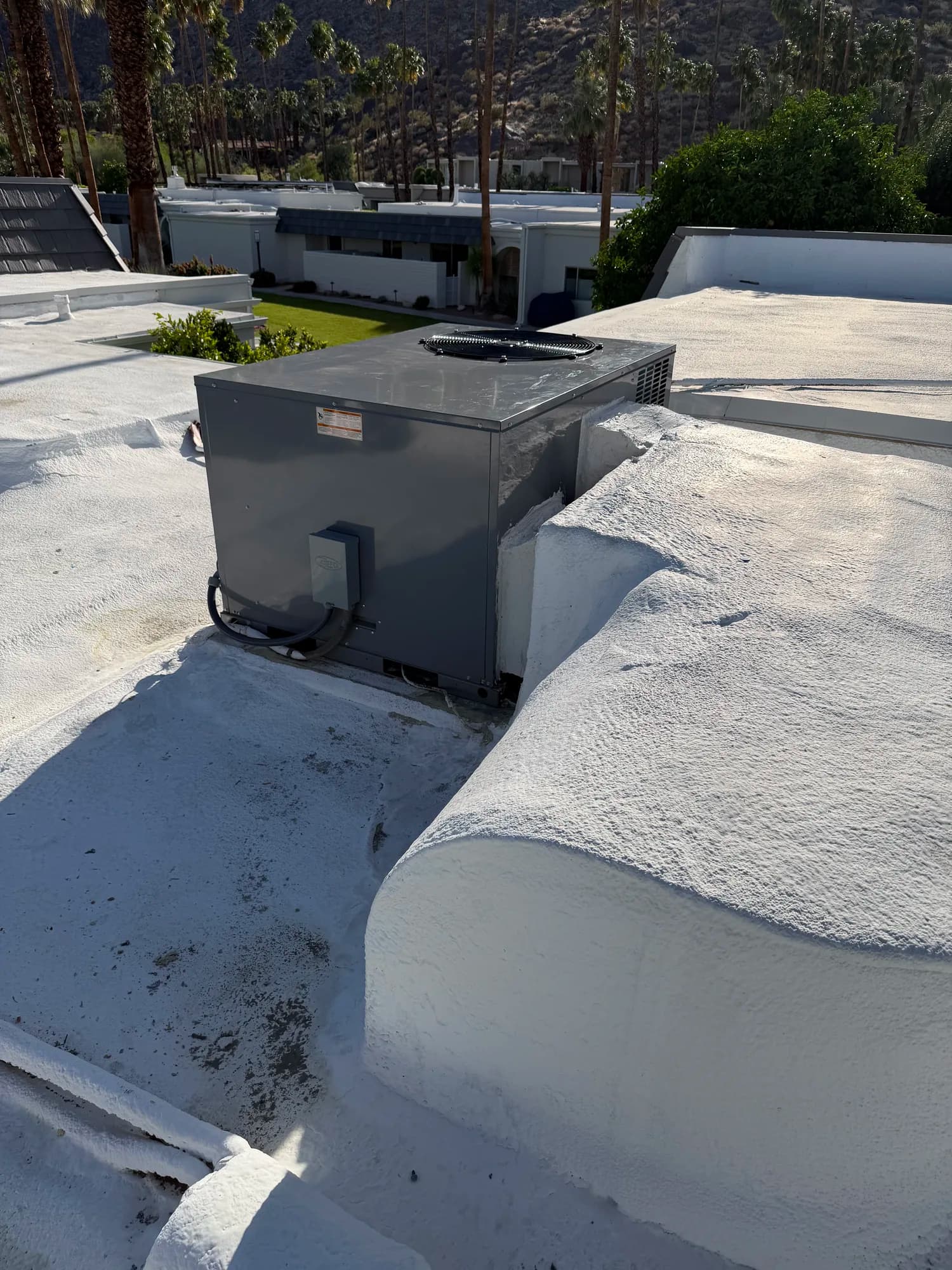 Residential rooftop package unit overlooking a courtyard